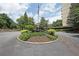 Circular driveway and well-manicured landscaping with American flag and building in the background at 1800 Clairmont Lk # 213, Decatur, GA 30033