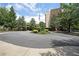 Circular driveway and well-manicured landscaping with American flag and building in the background at 1800 Clairmont Lk # 213, Decatur, GA 30033