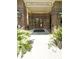 Covered entrance to 2100 Clairmont Lake with brick columns, double doors and flowers on display at 1800 Clairmont Lk # 213, Decatur, GA 30033
