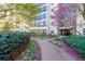Apartment building with a garden path, colorful flowers, and a lush green lawn at 1800 Clairmont Lk # 213, Decatur, GA 30033