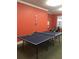 Game room features a ping pong table and painted orange accent wall at 1800 Clairmont Lk # 213, Decatur, GA 30033