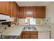 Kitchen features oak cabinets, laminate counters, and essential appliances at 1800 Clairmont Lk # 213, Decatur, GA 30033