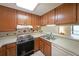 The kitchen features oak cabinets, laminate countertops, and essential appliances at 1800 Clairmont Lk # 213, Decatur, GA 30033