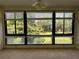 Bright living room featuring large windows with views of lush greenery at 1800 Clairmont Lk # 213, Decatur, GA 30033