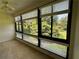 Living room featuring large windows with views of lush greenery at 1800 Clairmont Lk # 213, Decatur, GA 30033