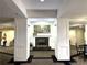 Elegant lobby area featuring a fireplace, decorative pillars, and artwork at 1800 Clairmont Lk # 213, Decatur, GA 30033