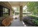 Covered patio area with bench seating, brick columns and lush landscaping with shade trees at 1800 Clairmont Lk # 213, Decatur, GA 30033