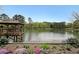 Scenic view of the pond with a wooden gazebo, surrounded by colorful flowers and mature trees at 1800 Clairmont Lk # 213, Decatur, GA 30033