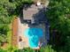 Aerial view of sparkling blue pool surrounded by green trees near a building with a brown roof at 24 Dunwoody Springs Dr, Atlanta, GA 30328
