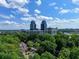 Lush green trees surrounding houses with city buildings in the distance, captured in this aerial view at 24 Dunwoody Springs Dr, Atlanta, GA 30328