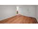 A well-lit bedroom with hardwood floors, a closet, and a door at 24 Dunwoody Springs Dr, Atlanta, GA 30328