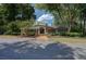 Beautiful low, one-story clubhouse with stone accents surrounded by lush trees and well-maintained landscaping at 24 Dunwoody Springs Dr, Atlanta, GA 30328