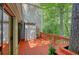 Outdoor deck featuring a tree, red-stained wood, and sliding door access to the house at 24 Dunwoody Springs Dr, Atlanta, GA 30328