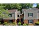 Charming two-story townhome featuring neutral siding, brick accents, and well-maintained landscaping at 24 Dunwoody Springs Dr, Atlanta, GA 30328