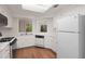 Bright kitchen featuring white cabinetry, black appliances, wood flooring, and a skylight at 24 Dunwoody Springs Dr, Atlanta, GA 30328