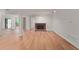 Bright and open living room featuring wood floors, a cozy fireplace, and sliding glass doors to deck at 24 Dunwoody Springs Dr, Atlanta, GA 30328