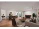Staged living room with neutral walls, fireplace, wood floors, and ample natural light at 24 Dunwoody Springs Dr, Atlanta, GA 30328