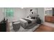 Serene main bedroom with a neutral palette, wood floors, a window, and adjacent bathroom vanity at 24 Dunwoody Springs Dr, Atlanta, GA 30328