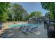 Sparkling pool with lounge chairs and a two-story building with an open-air deck overlooking the water at 24 Dunwoody Springs Dr, Atlanta, GA 30328