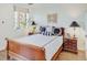 This bedroom features a wooden sleigh bed, decorative pillows, and two matching wooden nightstands at 300 Johnson Ferry Ne Rd # A706, Atlanta, GA 30328