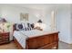 This bedroom features a wooden sleigh bed, decorative pillows, and two matching wooden nightstands at 300 Johnson Ferry Ne Rd # A706, Atlanta, GA 30328