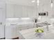 Bright white kitchen with marble countertops, stainless steel appliances, and modern pendant lighting at 300 Johnson Ferry Ne Rd # A706, Atlanta, GA 30328