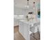 Charming kitchen with marble waterfall island, stainless appliances, pendant lights, and white shaker cabinets at 300 Johnson Ferry Ne Rd # A706, Atlanta, GA 30328