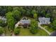 Aerial view of a home nestled among mature trees with a pool and well-manicured lawn, plus neighboring properties at 680 Parkside Trl, Marietta, GA 30064