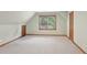 Carpeted attic space with dormer windows, sloped ceiling and doors, offering potential for storage or conversion at 680 Parkside Trl, Marietta, GA 30064