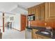Basement bar area with wood cabinets, a mini fridge, microwave, and a sink, great for entertaining at 680 Parkside Trl, Marietta, GA 30064