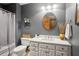 Bathroom featuring a white vanity, round mirror, and modern fixtures, creating a calming and stylish space at 680 Parkside Trl, Marietta, GA 30064