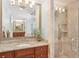 Bright bathroom boasting granite countertops, wooden cabinets, and a tiled shower at 680 Parkside Trl, Marietta, GA 30064