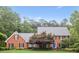 Charming two-story brick home with manicured lawn, mature trees, and blue front door at 680 Parkside Trl, Marietta, GA 30064