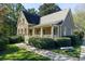 Charming stone and siding home with a covered front porch and well-manicured landscaping at 680 Parkside Trl, Marietta, GA 30064