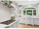 Charming kitchen with white cabinets, quartz counters, designer backsplash, and views of the backyard at 680 Parkside Trl, Marietta, GA 30064