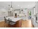 Open kitchen features a large island with seating, stainless steel appliances, and custom white cabinets at 680 Parkside Trl, Marietta, GA 30064