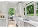 Bright kitchen with white cabinets, stainless steel appliances, and a view of the backyard and deck at 680 Parkside Trl, Marietta, GA 30064