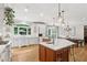 Spacious kitchen with a large island, stainless steel appliances, white cabinets, and hardwood floors at 680 Parkside Trl, Marietta, GA 30064
