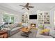Cozy living room featuring built-in bookshelves, fireplace, and access to the outdoor patio at 680 Parkside Trl, Marietta, GA 30064