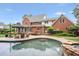 Beautiful in-ground pool surrounded by a stone patio and lush landscaping, perfect for outdoor relaxation at 680 Parkside Trl, Marietta, GA 30064