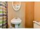 This bathroom has a pedestal sink with a mirror, and a toilet at , Atlanta, GA 30310