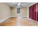 Bedroom with hardwood floors and a window with a blind, offering a cozy and private space at , Atlanta, GA 30310