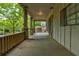 Inviting front porch with wooden railing, stone pillars, and ample space for relaxing and enjoying the outdoors at , Atlanta, GA 30310