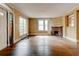 Spacious living room with hardwood floors, a brick fireplace, and large windows providing natural light at , Atlanta, GA 30310