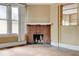 Living room showcasing a brick fireplace, hardwood floors, and windows with natural light at , Atlanta, GA 30310
