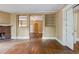 Open-concept living room featuring hardwood floors, a brick fireplace, and built-in shelving, offering ample space at , Atlanta, GA 30310