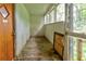 Sunroom needing repair, with wood floor, paneled wall, and lots of windows at , Atlanta, GA 30310