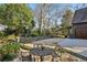 Backyard patio with a table and chairs, manicured yard, and greenery at 1031 Eulalia Ne Rd, Atlanta, GA 30319