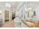 Bright bathroom features a soaking tub, marble countertops, and a glass enclosed shower at 1031 Eulalia Ne Rd, Atlanta, GA 30319