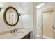 Lavish bathroom with dark vanity, round mirror, and marble shower at 1031 Eulalia Ne Rd, Atlanta, GA 30319